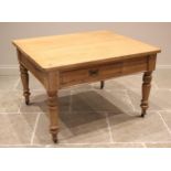 A Victorian pine kitchen table, the rectangular slab top with rounded corners above a single