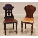 A Victorian mahogany hall chair, the arched back centred with an openwork shield and foliate motif