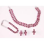 A suite of ruby set jewellery, comprising an oval cut ruby necklace with matched bracelet, a pair of