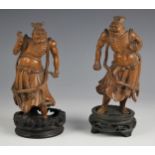 A pair of Chinese carved boxwood figures, late 19th/early 20th century, each modelled as an immortal