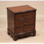 A small reproduction mahogany chest of drawers, late 20th century, with a crossbanded top over three