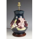 A Moorcroft table lamp, 20th century, of squat baluster form, decorated in the Purple Magnolia
