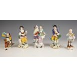 Five continental porcelain figural groups, 19th century and later, comprising: a Volkskedt harlequin