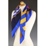 A Christian Dior silk scarf, the abstract stripe design scarf in red, blue, yellow, brown and white,