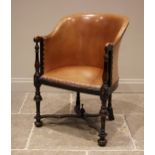 A Carolean revival beech and tan leather tub chair, early 20th century, the leather upholstered seat