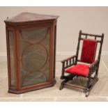 An Edwardian mahogany hanging glazed corner display cabinet, with a moulded simulated dentil