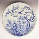 A large Japanese Arita porcelain blue and white charger, Meiji period (1868-1912), of circular