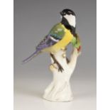 A Meissen porcelain model of a Great Tit, 19th century, perched upon a branch with gilt