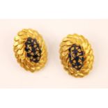 A pair of sapphire and yellow metal earrings, the central thirteen round cut sapphires in a raised