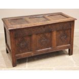 A carved oak coffer, late 17th/early 18th century, the three panel hinged top (detached), over a