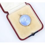 A 20th century guilloche enamel pendant/locket, the circular pendant with light blue guilloche