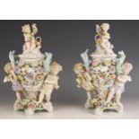 A pair of German porcelain pot pourri and covers, 19th century, each modelled with cherubs