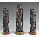 A set of three Chinese carved wood and metal inlaid figures of sages, early 20th century, each