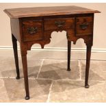 A George II oak and elm low boy, mid 18th century, the rectangular moulded top over an arrangement