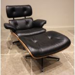 A Charles and Ray Eames style rosewood reclining chair and ottoman, late 20th century, having black