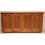 A large Victorian pitch pine ecclesiastical hall cupboard, formed with two pairs of panelled