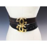 A Gucci black leather belt, stamped 'Made in Italy by Gucci' with attached gilt metal double G
