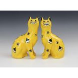 A pair of Griselda Hill Pottery Wemyss cats, 21st century, painted with heart and circular motifs to