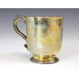 A Victorian silver gilt christening mug, R & S Garrard and Co, London 1865, the scroll handle