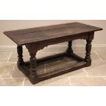 An 18th century oak refectory table, the cleated plank top upon turned vase and block shaped legs,