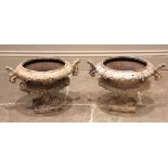 A pair of 19th century cast iron garden/patio urns, of compressed campana form, the leaf cast rims