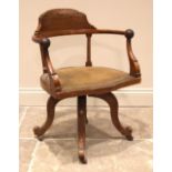 A walnut revolving office/desk chair, by Maple & Co, late 19th/early 20th century, with a demi