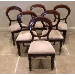 A set of six Victorian mahogany balloon back dining chairs, each with a drop-in upholstered seat,