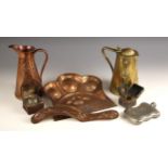 A collection of Art Nouveau brass and copper, comprising; two jugs and a crumb tray and brush,