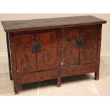 A Chinese painted and lacquered sideboard, probably elm, 19th century, the cleated plank top over