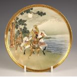 A Japanese Satsuma porcelain dish, Meiji Period (1868-1912), the shallow circular dish painted