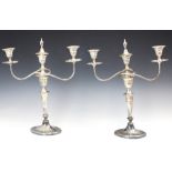 A pair of Edwardian silver candelabra, Hawksworth, Eyre & Co Ltd, Sheffield 1905, the three urn