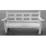 A Country house painted hardwood garden/patio bench, of slatted form, the arm supports extending