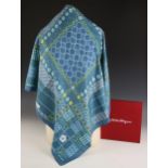 A Salvatore Ferragamo silk scarf, decorated in geometric design with flowers, spots and logo in