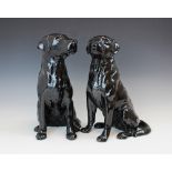 Two Beswick Fireside series models of Black Labradors, model no. 2314, modelled seated, printed