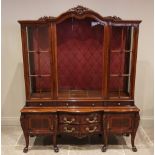 An Italian carved walnut display cabinet, mid 20th century, of break arch form, the central