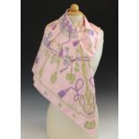 An Hermes silk scarf, in the 'Les Cles' pattern, in pink, lilac and gold tones, with rolled hems,
