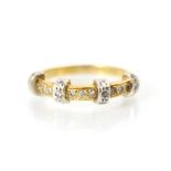 An 18ct yellow gold diamond ring, the band ring with four raised white metal diamond set sections