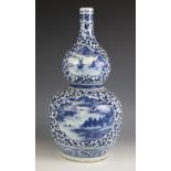 A large Chinese porcelain blue and white double gourd vase, 19th century, the lower body decorated