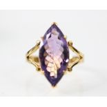 An untested amethyst dress ring, the marquise cut amethyst six claw set in yellow metal, leading
