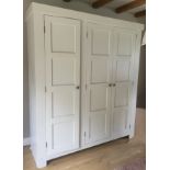 A large custom-made painted housekeepers/ hall cupboard, late 20th century, the three panelled doors