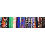 Eleven Jacqmar silk scarves, to include geometric floral, polka dot and plain examples along with