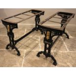 A pair of Victorian painted cast iron pub tables, each raised upon twin trestle type supports,