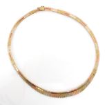 A multi tone 9ct yellow gold collar necklace, the necklace designed as a fringe with planished