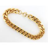 A gold coloured metal bracelet, the curb link bracelet with bolt ring fastener, overall length 20.