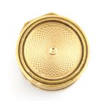 A 20th century gold coloured vinaigrette, the circular hinged cover with concentric engine turned