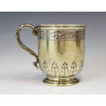 A Victorian silver gilt christening mug, Daniel and Charles Houle, London 1868, the scroll handle