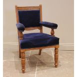 A Victorian golden oak and upholstered library/elbow chair, later re-covered in blue velour, the