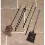 A set of three George III steel and brass fire implements, each with a brass button terminal