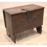 A 17th century oak six plank oak coffer bach, the hinged cover with a serrated edge and iron clasp