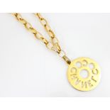 A Coco Chanel gold coloured pendant and chain, the circular pendant of medallion style with openwork
